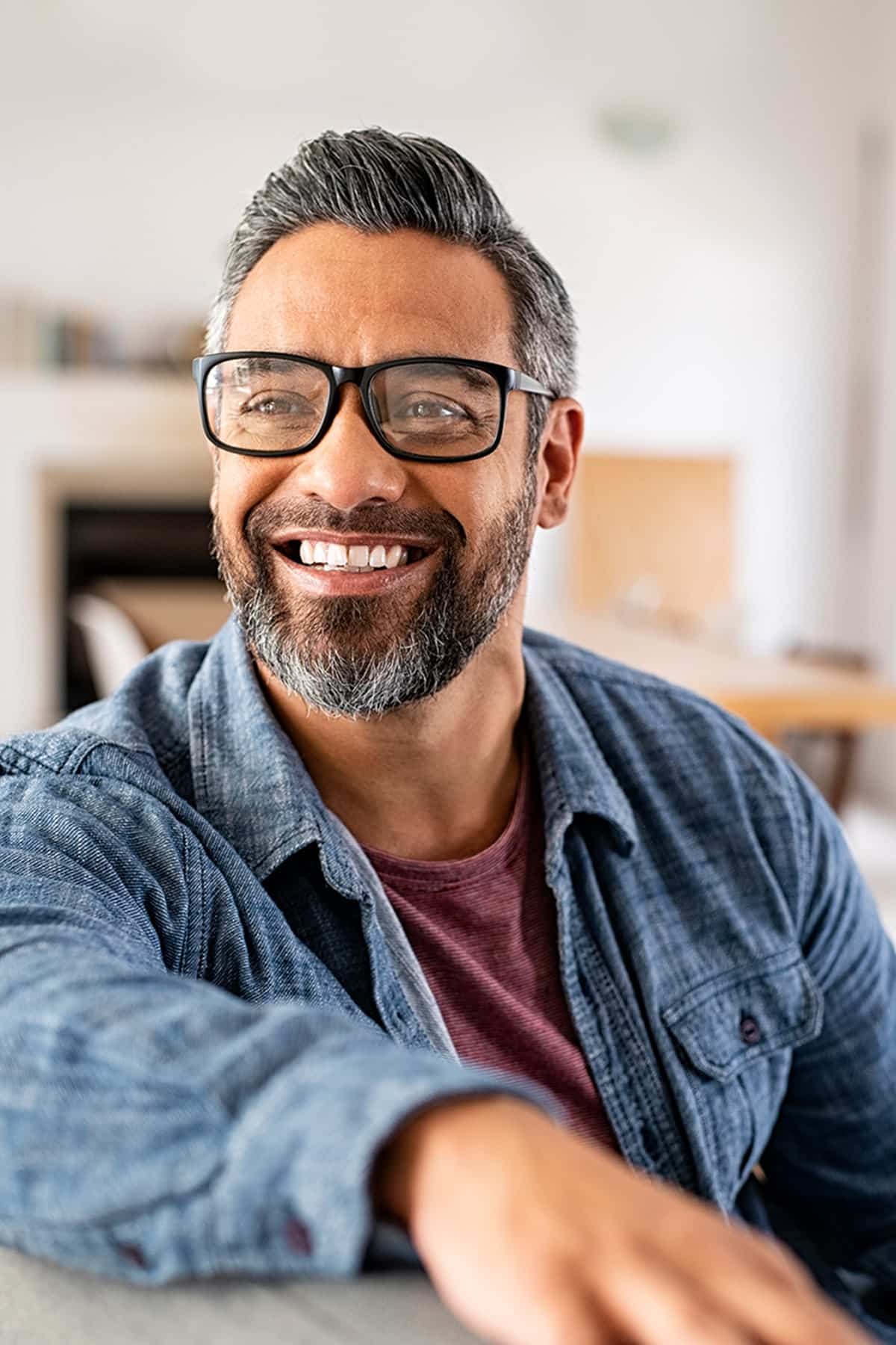 A young woman laying down in a dental chair smiling at esteem dental studio