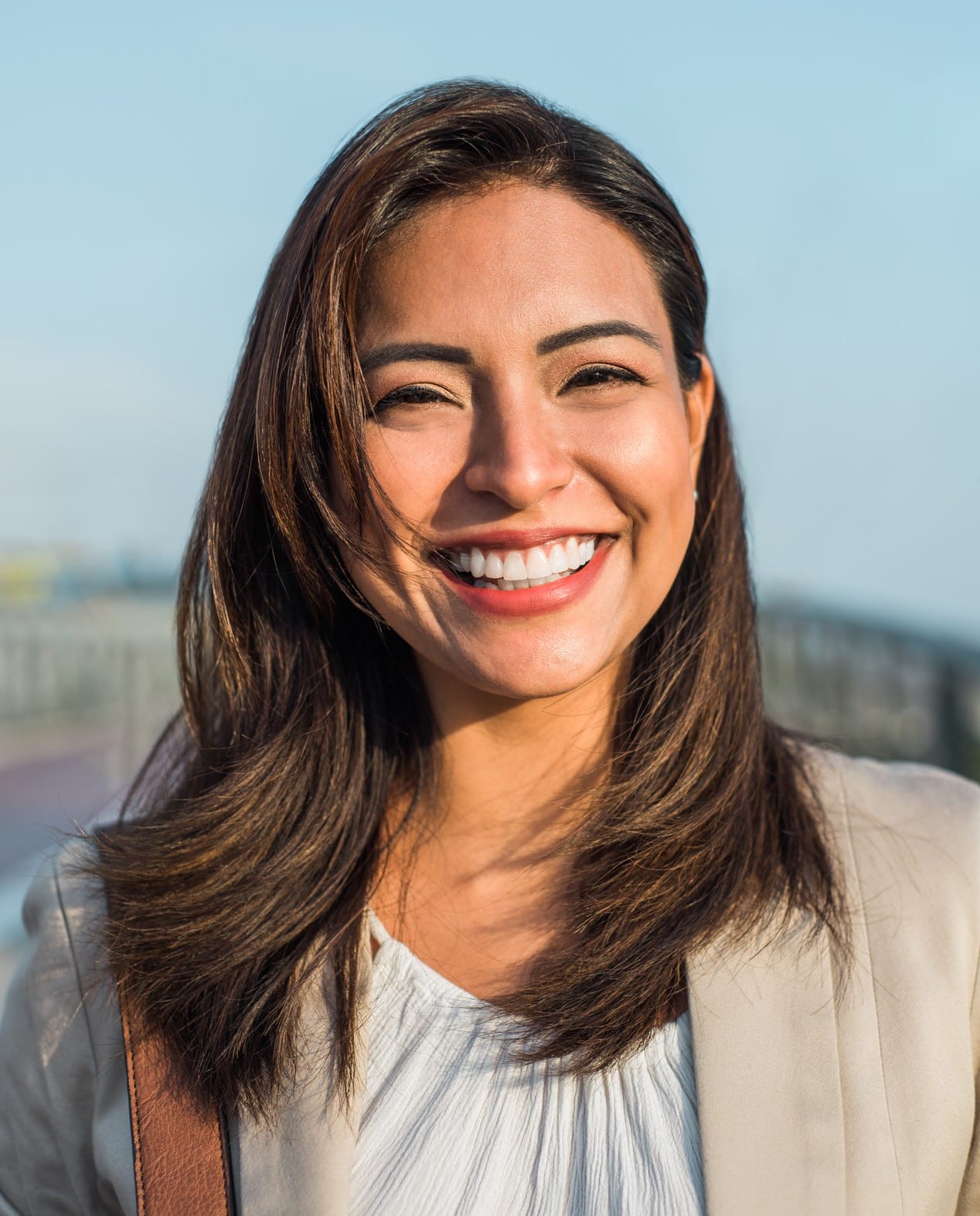 A young woman laying down in a dental chair smiling at esteem dental studio