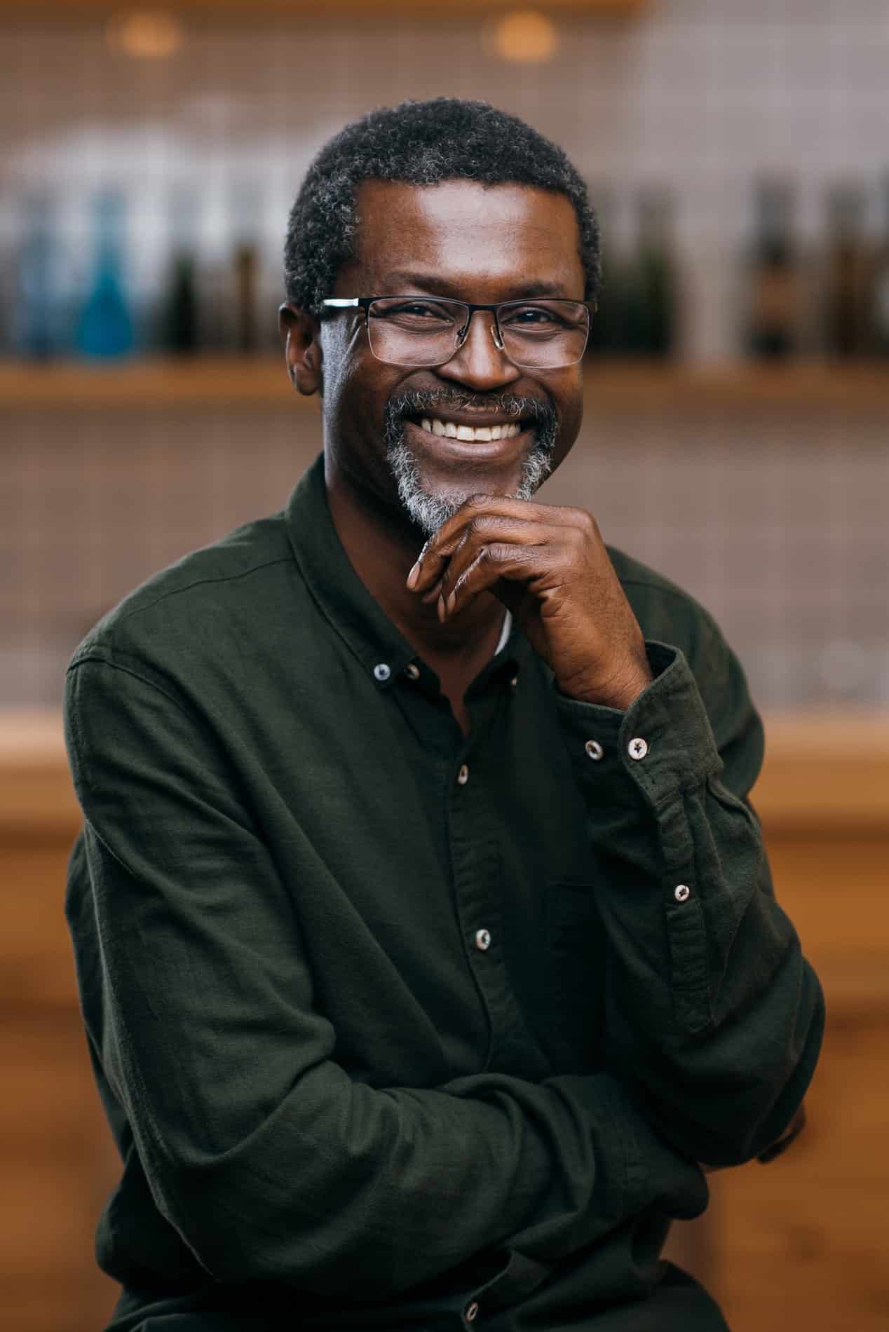 A young woman laying down in a dental chair smiling at esteem dental studio