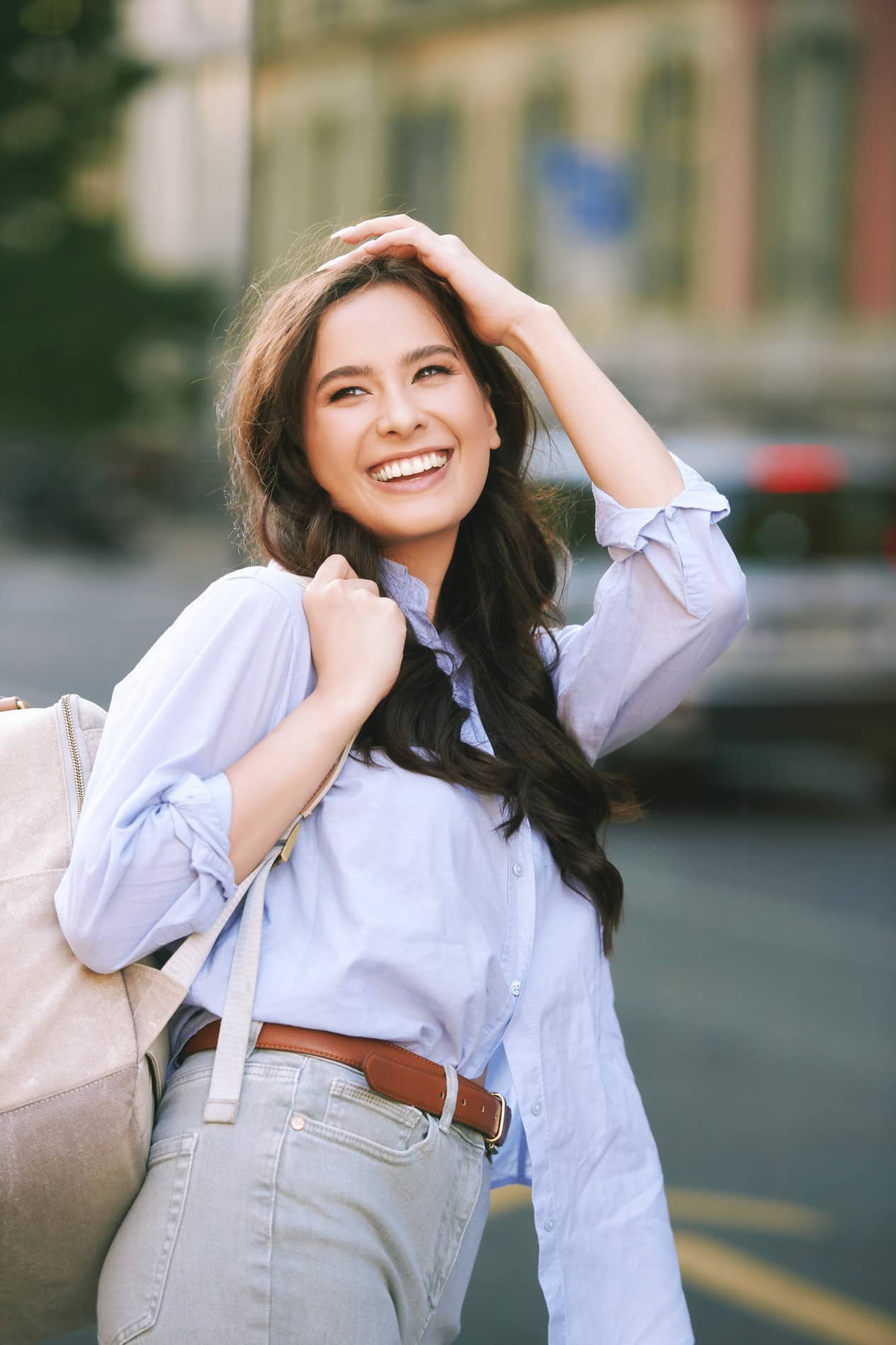 Woman smiling after her dental filling with Dr. Thachil and Dr. Watts