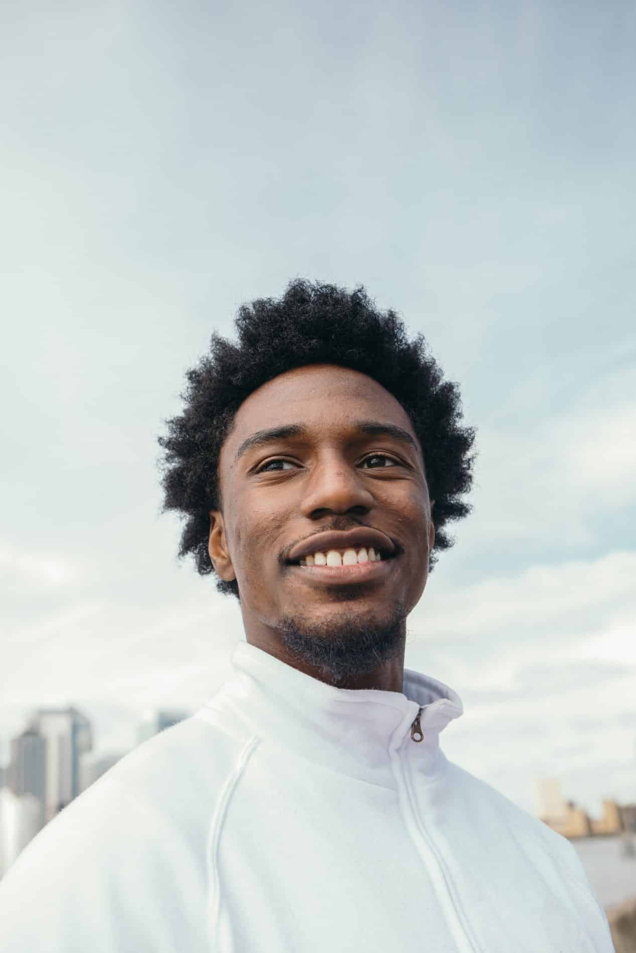 A young woman laying down in a dental chair smiling at esteem dental studio