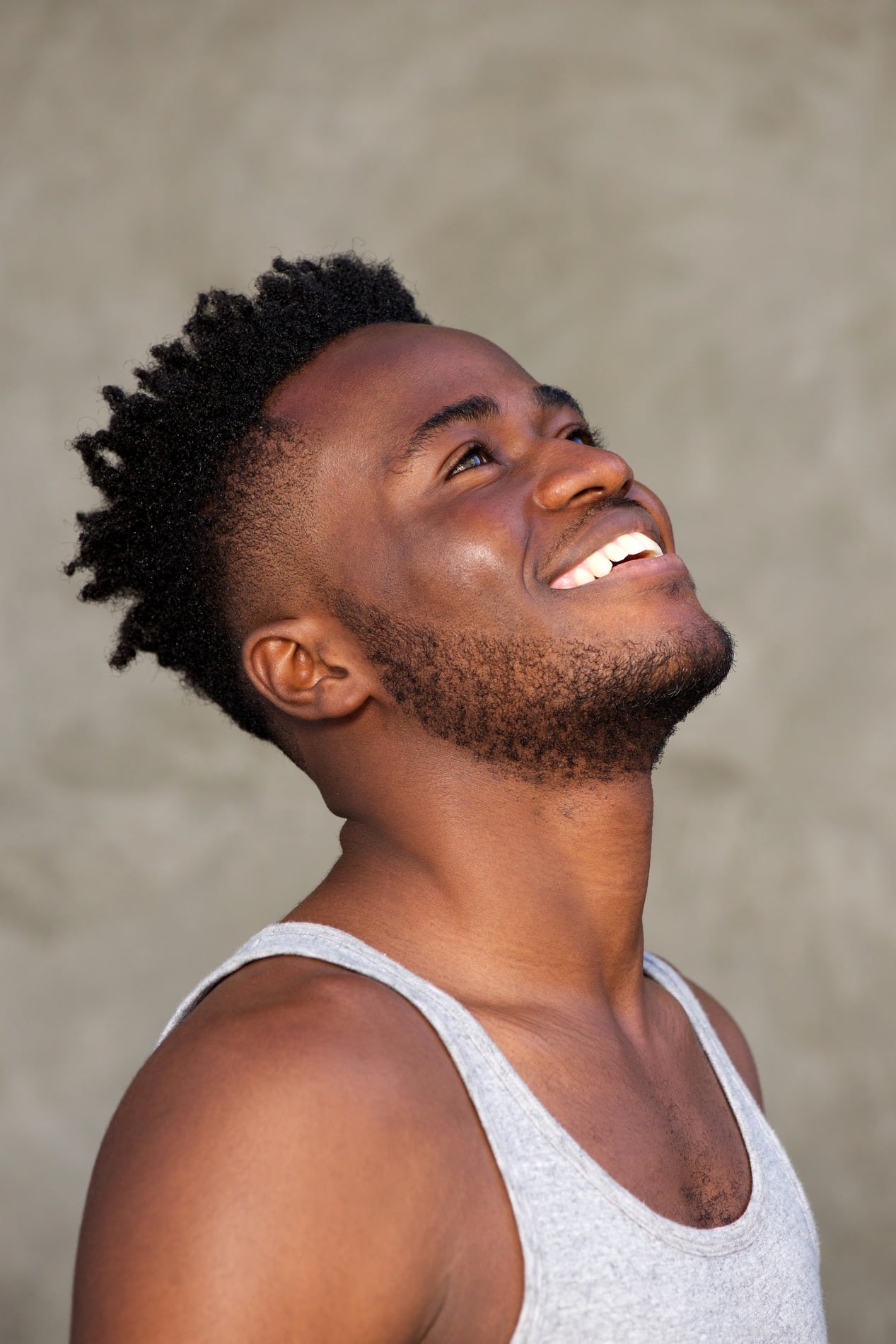 A young woman laying down in a dental chair smiling at esteem dental studio