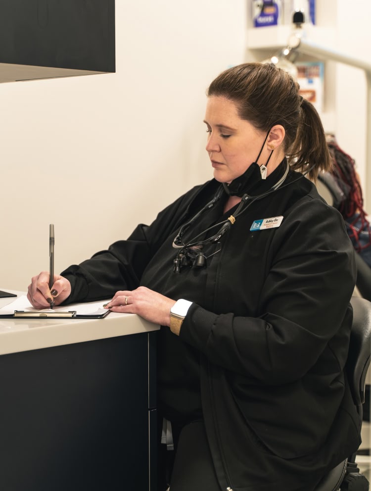 A close up of a young woman getting her teeth polished by a dentist at esteem dental studio