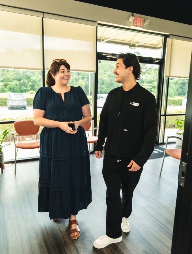 A group of older adults outside during a sunset, smiling and laughing together in powder springs ga