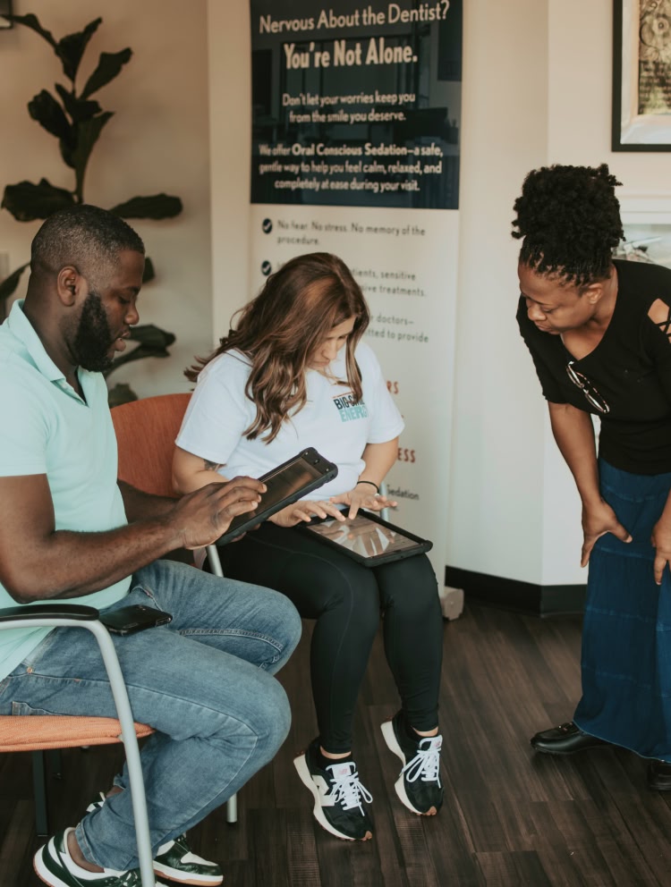 An older woman checking out her smile in a handheld mirror at esteem dental studio