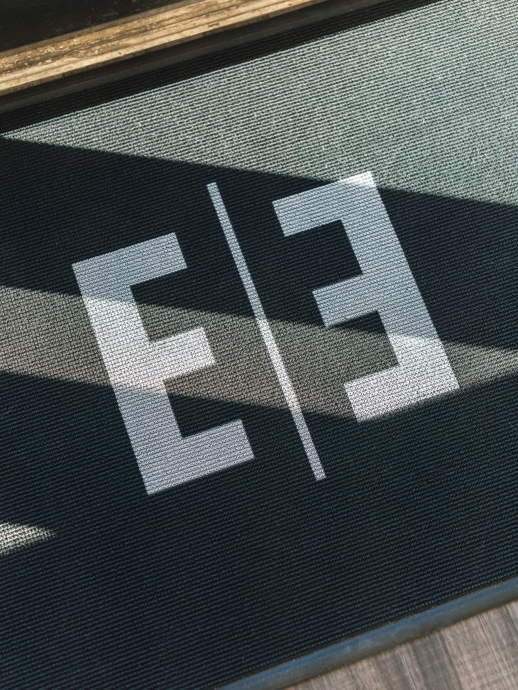 A young woman smiling up from a dental chair at esteem dental studio