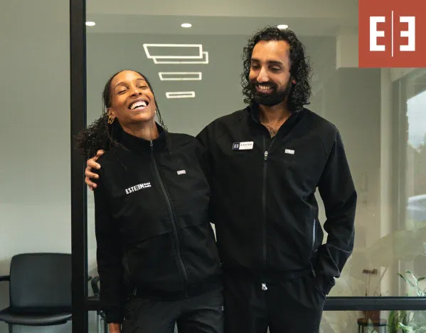 man smiling at a dentist while sitting in a dental chair at esteem dental studio