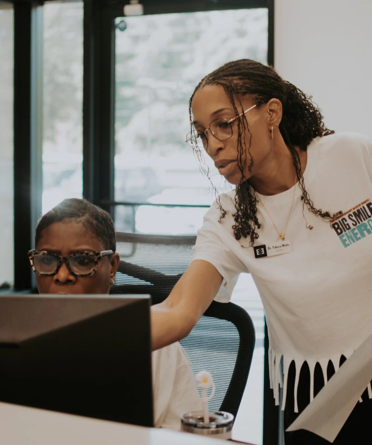 A young woman laying down in a dental chair smiling at esteem dental studio