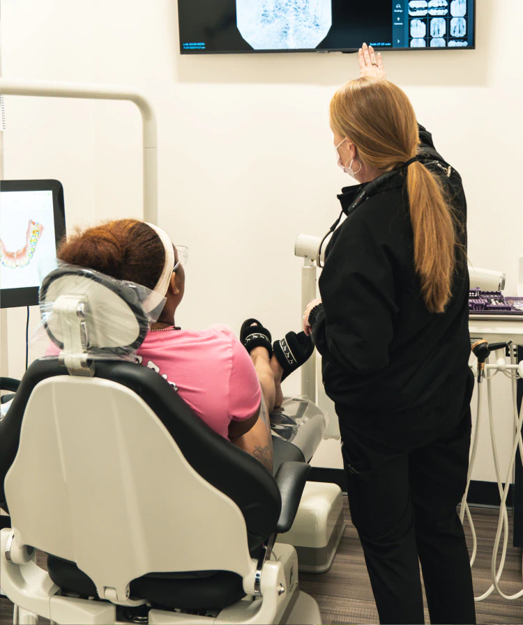 A young woman having a dental exam preformed AT esteem dental studio